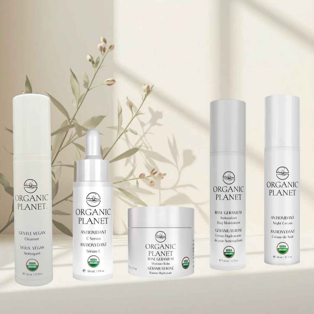 A complete 5-piece USDA Organic skincare set including cleanser, serum, day and night creams, and moisture balm in elegant glass packaging. Collection of Organic Planet skincare products on a neutral background with a subtle plant design.