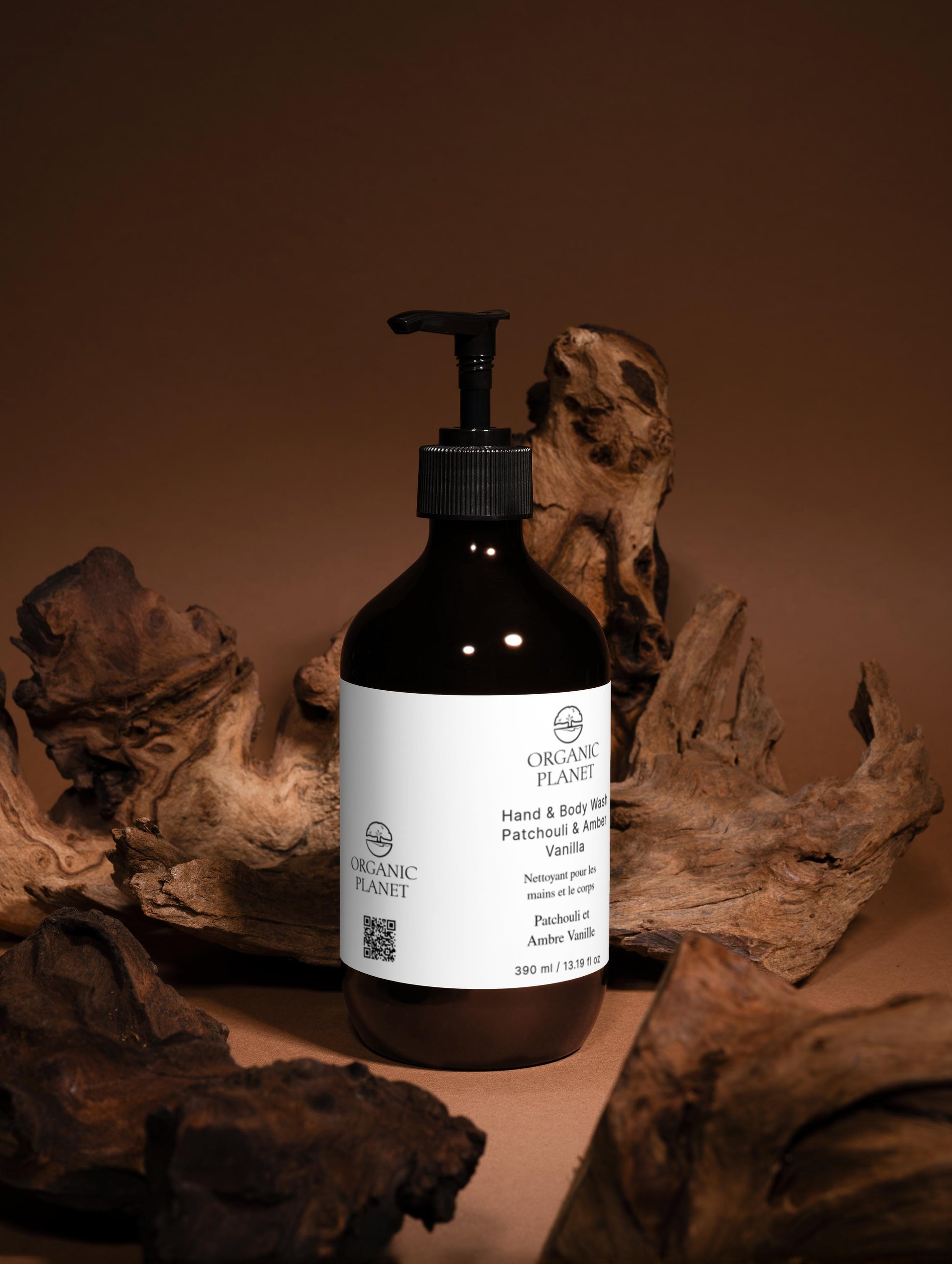 Pump bottle of ORGANIC PLANET Hand and Body Wash, Patchouli & Vanilla with a brown background.